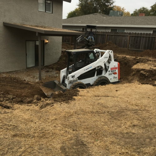 Skid steer loader working on a landscaping project