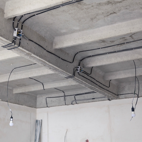 Exposed electrical wiring on a ceiling