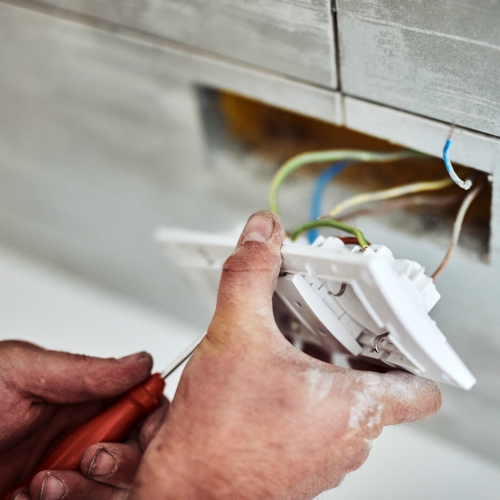 Electrician installing a light switch